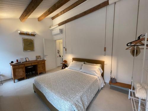 a bedroom with a bed and a desk in it at Due Di Tutto in Ferrara