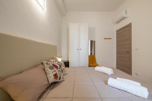 a white room with a bed and a couch at Via Roma 106 Apartment in Sassari