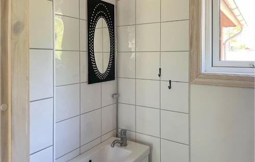 a bathroom with a mirror and a sink at Amazing Home In Vittaryd With Wifi in Kvänarp