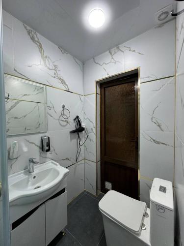 a bathroom with a sink and a toilet at Light Hotel in Samarkand