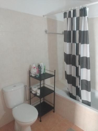 a bathroom with a toilet and a shower curtain at Oceania Bay Residence in Pyla