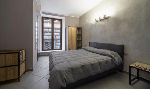 a bedroom with a large bed and a window at Il Taschino Suite in Naples