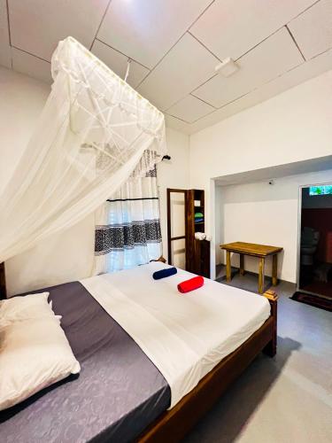 a bedroom with a bed with a mosquito net at 11 11 Weligama in Weligama