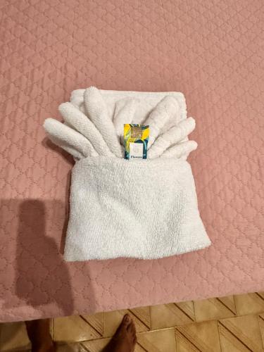 a pair of white gloves sitting on a table at Pousada Casa de Buzios in Búzios