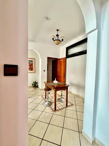 a dining room with a table and a hallway at Ambre appartement in Essaouira