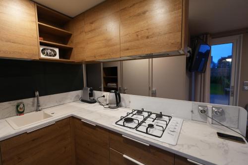 a kitchen with a stove and a counter top at Chalet Louise-marie in Jabbeke