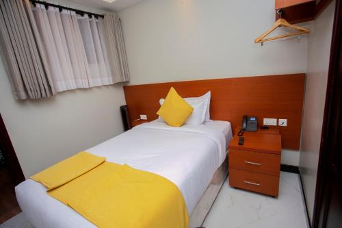 a hotel room with two beds and a telephone at Kaloni Hotels in Seeta