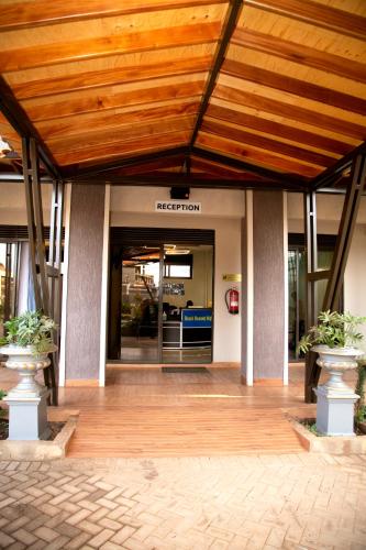an entrance to an office building with a wooden ceiling at Kaloni Hotels in Seeta