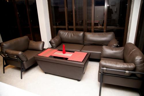 a living room with a leather couch and a table at Kaloni Hotels in Seeta