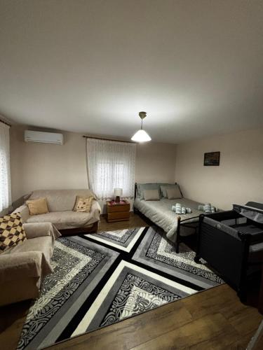 a living room with a couch and a table at Platanos Village Home in Tríkala