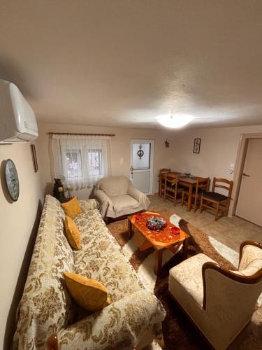a living room with a couch and a table at Platanos Village Home in Tríkala
