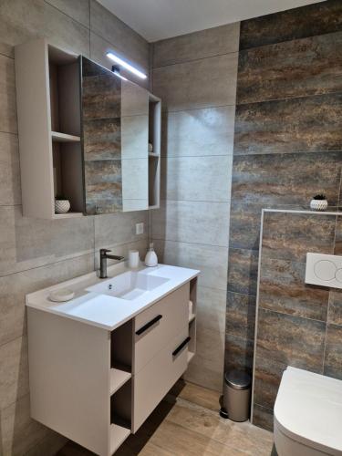 une salle de bain avec un lavabo blanc et une douche dans l'établissement chez Cyril et Celine, à Tignes