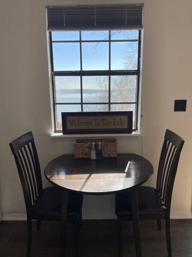 a table and two chairs in a room with a window at Lakehouse Getaway with Beautiful Views in Crowder