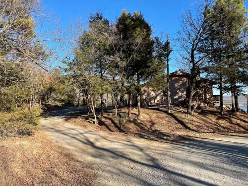 a road with trees on the side of a house at Lakehouse Getaway with Beautiful Views in Crowder