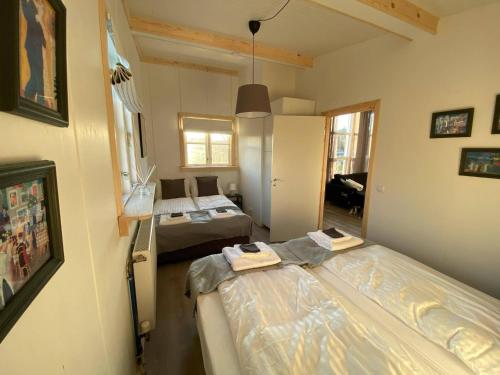a small room with two beds in it with a room with at Cozy Little Cottage In The Golden Circle no01 in Mosfellsbær