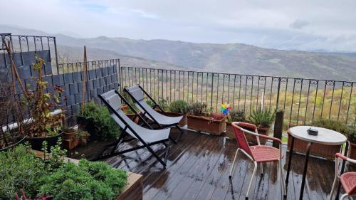 a deck with chairs and a table and a fence at B&B La Castellina in Abbadia San Salvatore