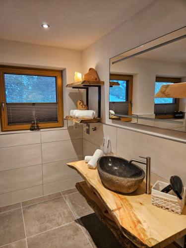 a bathroom with a sink and a mirror at Alpenchalet Lengau in Dornauberg