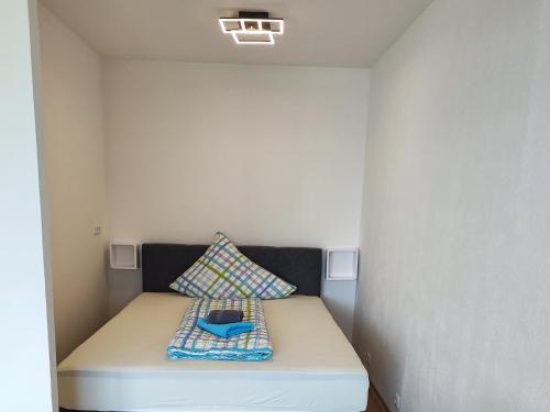 a small room with a bed with a pillow at Ferienwohnung - Apartment Pichlarn Holiday Grimmingblick in Aigen im Ennstal