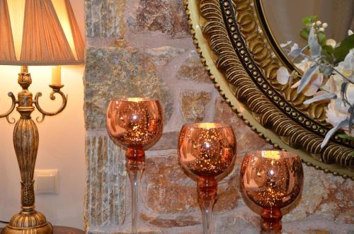 three wine glasses sitting in front of a mirror at Air Suite in Spáta