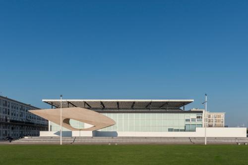 a building with a sculpture in front of it at ibis Le Havre Centre in Le Havre