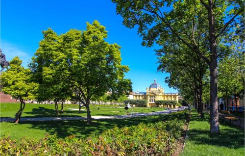 a park with trees in front of a building at Amazing Home In Susobreg With Wifi in Jertovec