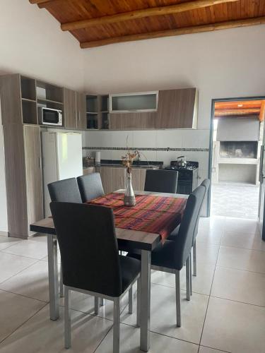 a dining room table and chairs in a kitchen at Complejo Turistico Los Troncos in San Rafael