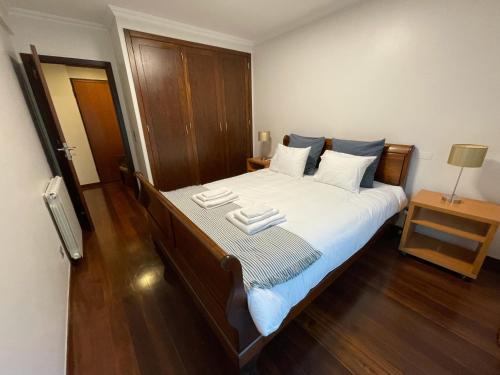 a bedroom with a bed with two towels on it at Apartamento Arrabida in Lisbon