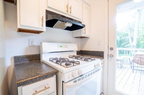 a white stove top oven in a kitchen with a porch at Your home away from home in the heart of the city in Atlanta