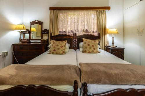 a bedroom with two beds and a window at HH 820 Accomodation in Groutfontein