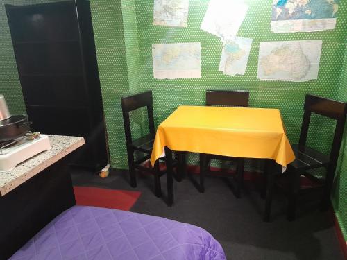 a table with chairs and a yellow table cloth on it at Posada Marisel in Chapadmalal