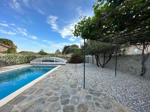 a house with a swimming pool and a garden at L'Olivette in Aubenas