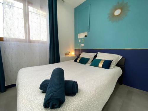 a bedroom with a large bed with a black object on it at Cozy studio 3min MER nice CENTRE in Nice