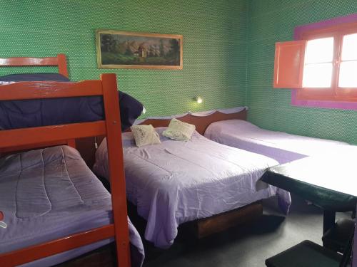 a bedroom with two bunk beds and a table at Posada Marisel in Chapadmalal