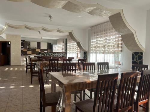 a dining room with wooden tables and chairs at Pensiunea Hanzu Darius in Gura Rîului