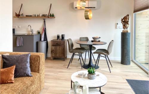 a living room with a couch and a table at Stunning House In Spakenburg in Spakenburg