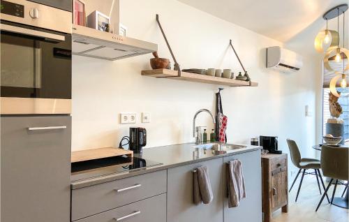 a kitchen with a sink and a counter at Stunning House In Spakenburg in Spakenburg