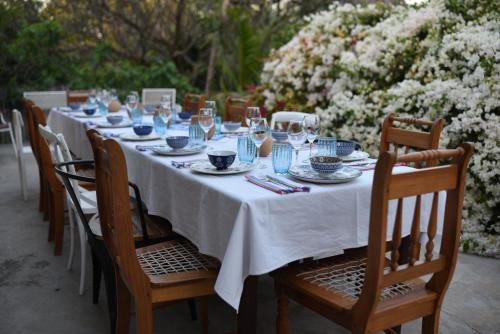 a long table with a white table cloth and chairs at HH 820 Accomodation in Groutfontein