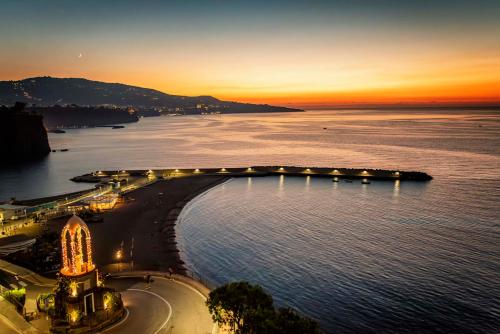a view of a beach at sunset with the ocean at Panorama Palace Hotel in Meta