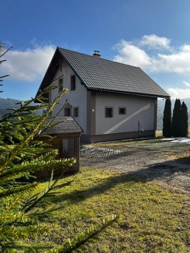 a white house with a black roof at Lesná Chata Barbara in Oravská Lesná