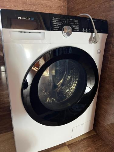 a white washing machine sitting in a room at Lesná Chata Barbara in Oravská Lesná