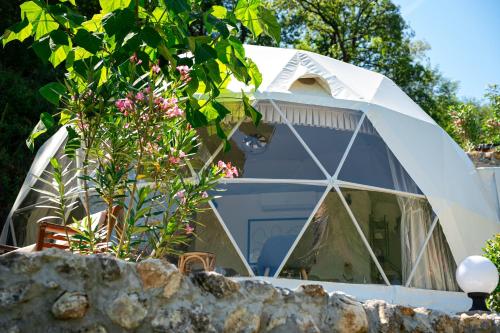 a dome tent in a yard with flowers at ZEN Relaxing Village in Cetinje