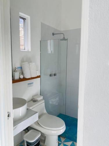 a bathroom with a toilet and a sink and a shower at Studios Downtown Cancun in Cancún