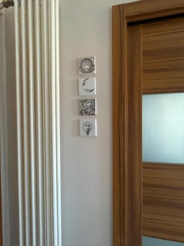a room with a door with four pictures on the wall at Domus Felix in Sorrento