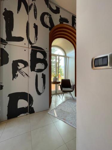 a hallway with a wall covered in blackletters at Domus Felix in Sorrento
