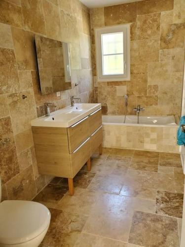 une salle de bain avec toilettes, lavabo et baignoire dans l'établissement Villa 7 ch, piscine chau,22 pers, au Thoronet