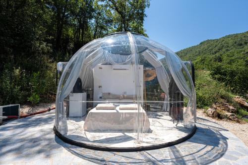 a clear tent with a bed inside of it at ZEN Relaxing Village in Cetinje