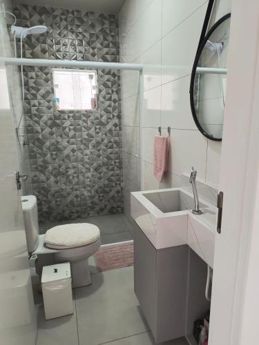a bathroom with a shower and a toilet and a sink at Apartamento Praia centro 03 in Penha