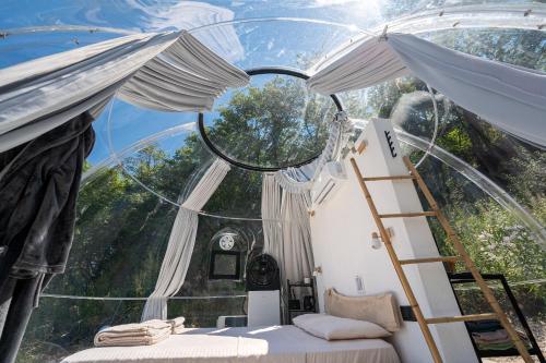 a room with a mirror and a ladder and a bed at ZEN Relaxing Village in Cetinje