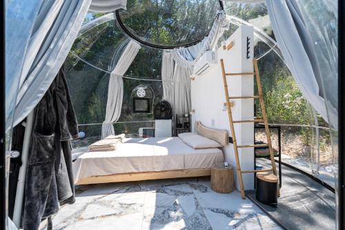 a bedroom with a bed in a tent at ZEN Relaxing Village in Cetinje