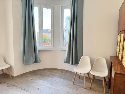 a room with three chairs and two windows at My place in Sofia - Top center - 2 bedrooms - Self check-in in Sofia
